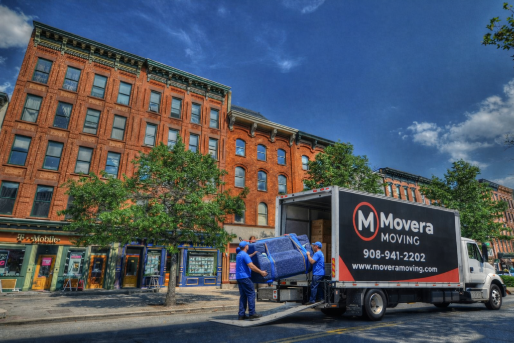 Hoboken NJ moving company loading a sofa with professional movers and a branded moving truck